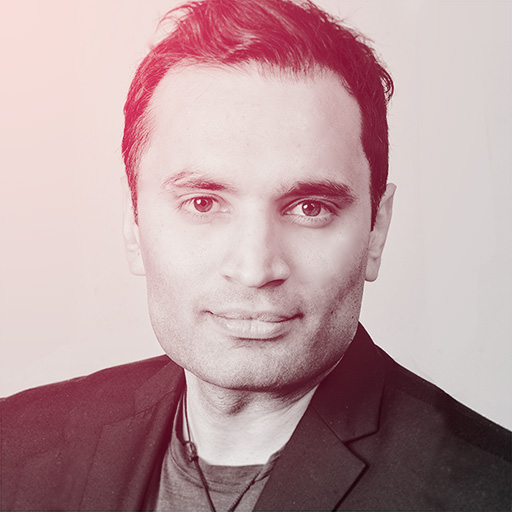 Middle aged Indian man no beard, short wavy hair, suited for radio.